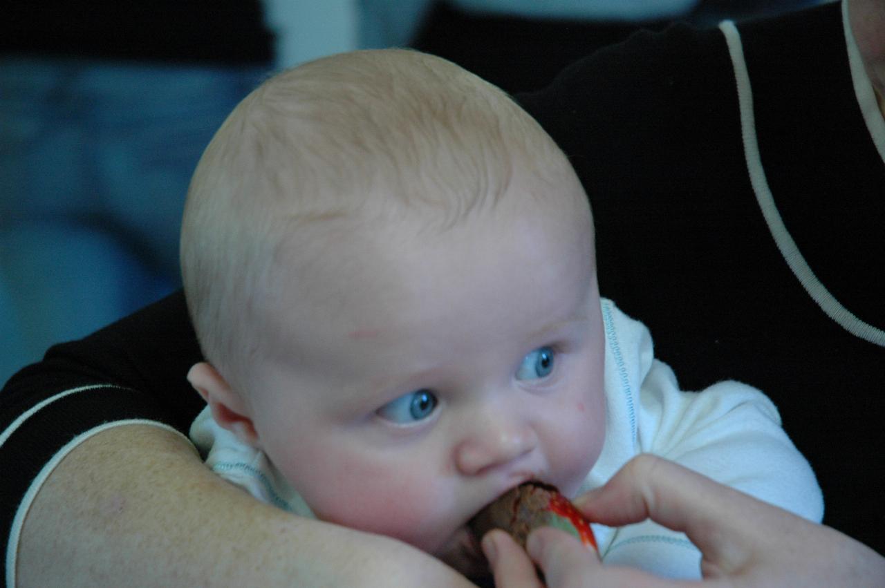 Cooper in Aunty Michelle's arms at his Baptismal celebration with chocolate coated strawberry