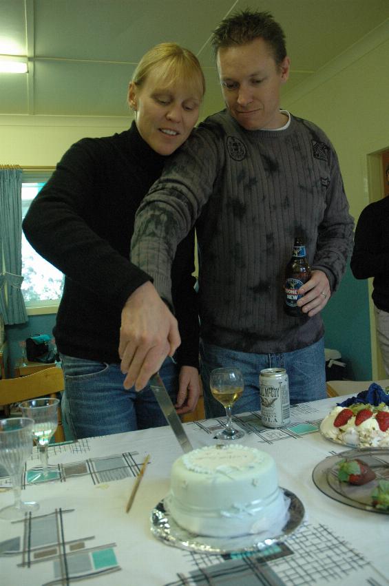 Kelly and Glenn Wallace cutting the cake (Baptismal now, formerly top tier of their wedding cake)