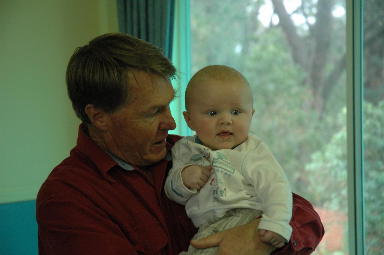 Chris Wallace with grandson Cooper after his Baptism