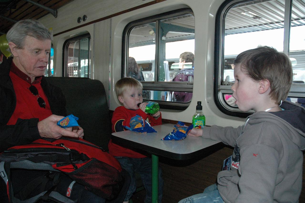 Peter handing out snacks to boys on steam train ride before leaving Central