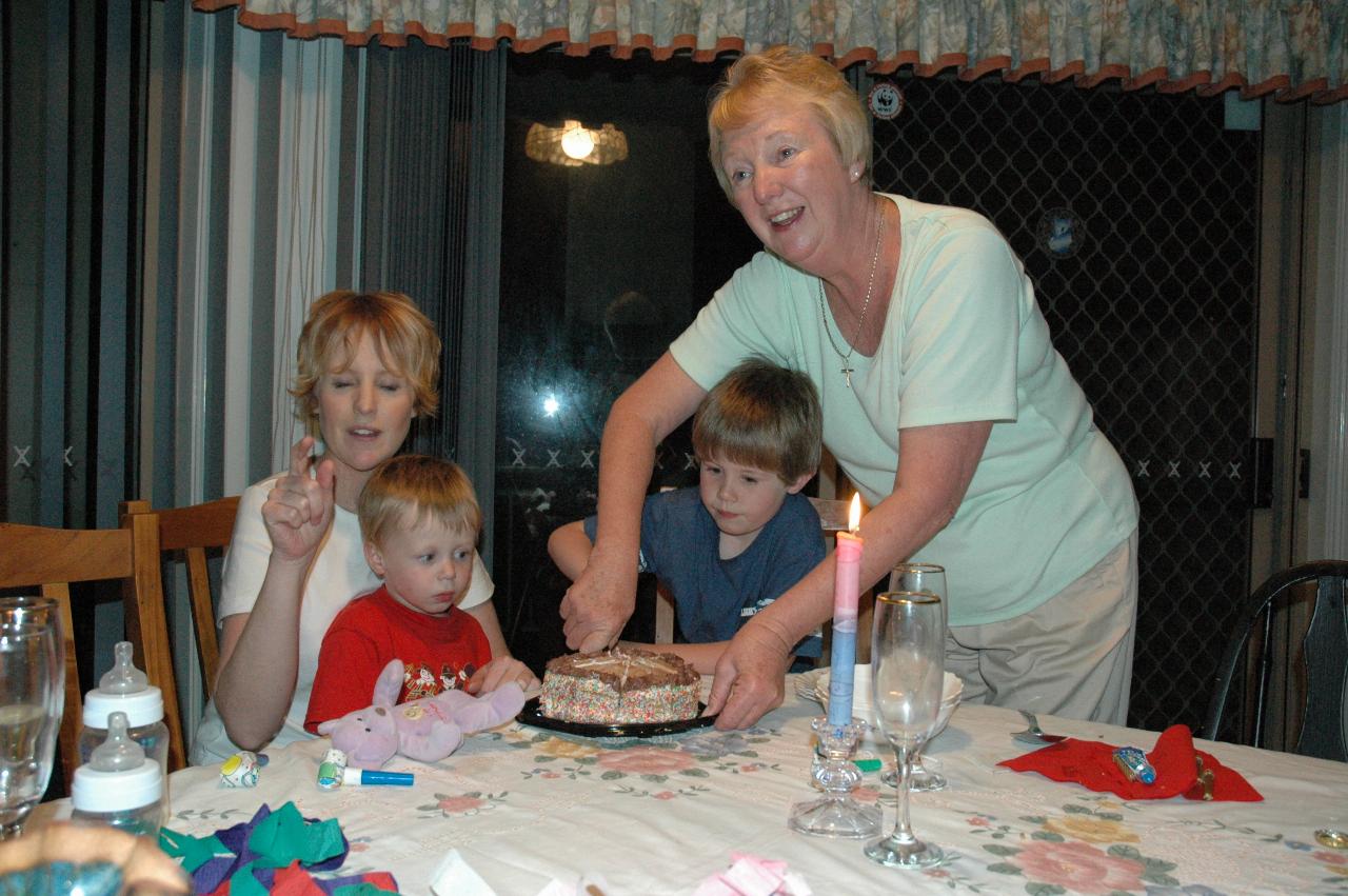 Jake and Yvonne cutting the cake at Michelle's birthday party