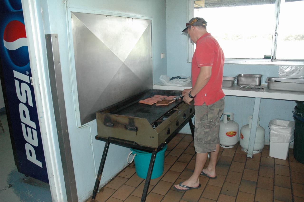 Tynan's 7th birthday party: Glenn cooking the sausages