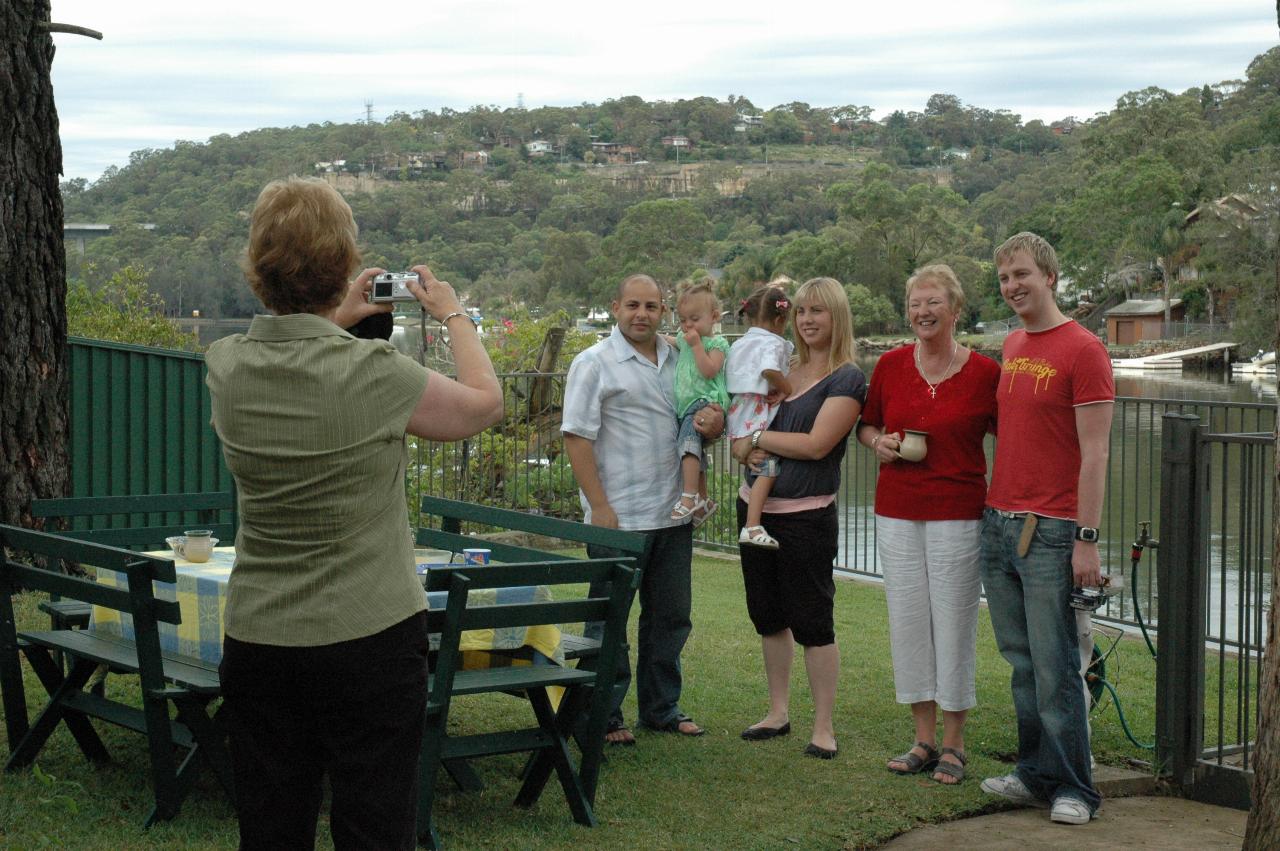 Christmas on Woronora: Di taking photo of Stephen with Bella, Nicole with Trinity, Yvonne and Keiran