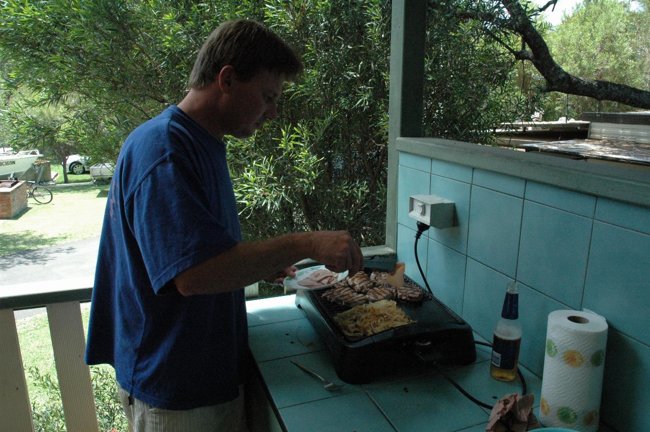 Cameron cooking steaks etc. on verandah at Bendalong