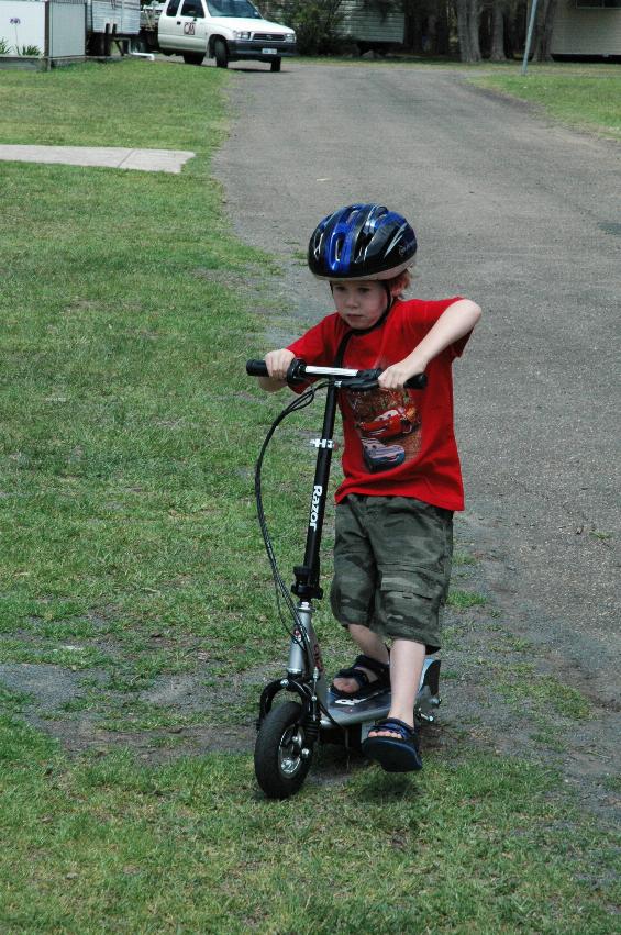 Jake coming to a stop on his electric scooter at Bendalong on afternoon walk