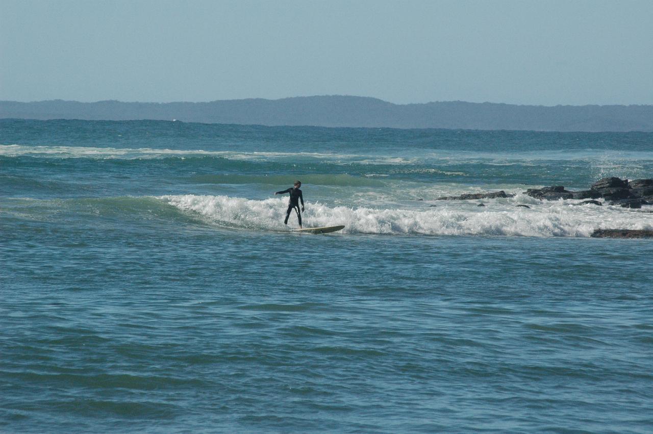 Surf board riders at Boat Harbour Beach at Bendalong