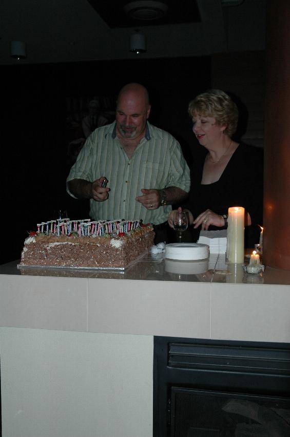 Peter about to light the candles on his cake, overseen by Sarah