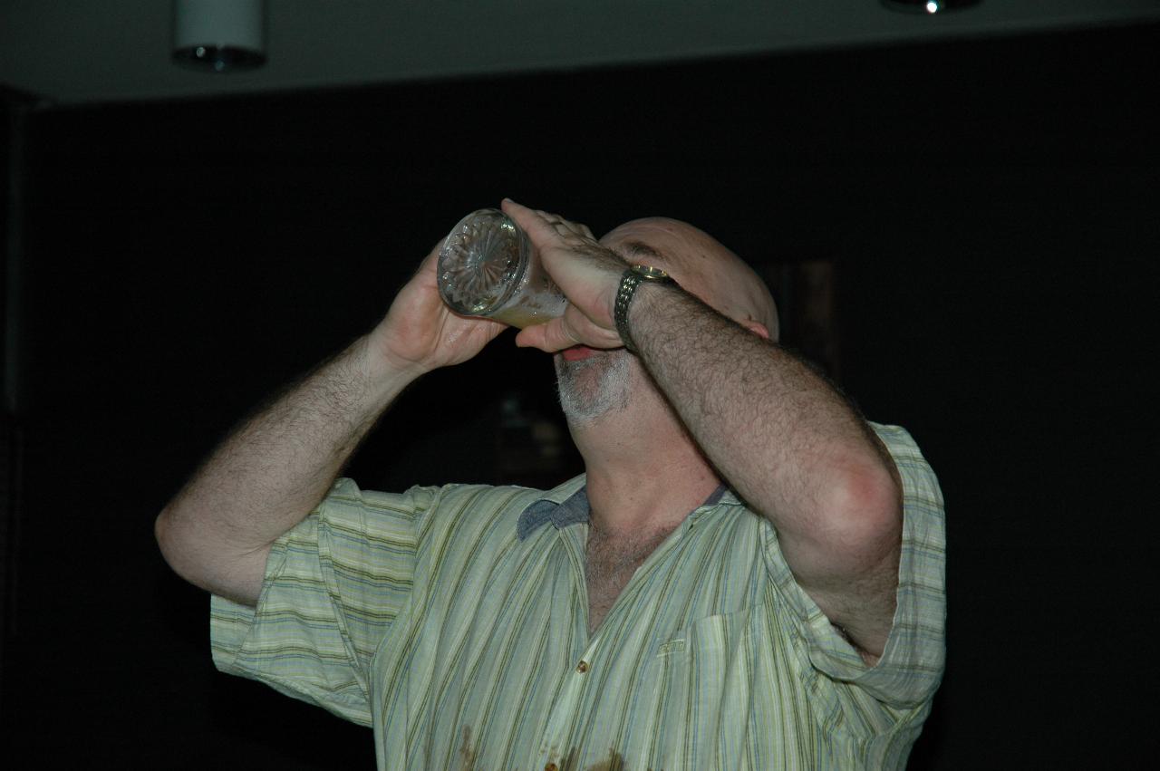 Old university tradition - drink the glass of beer in one gulp!  And he did.