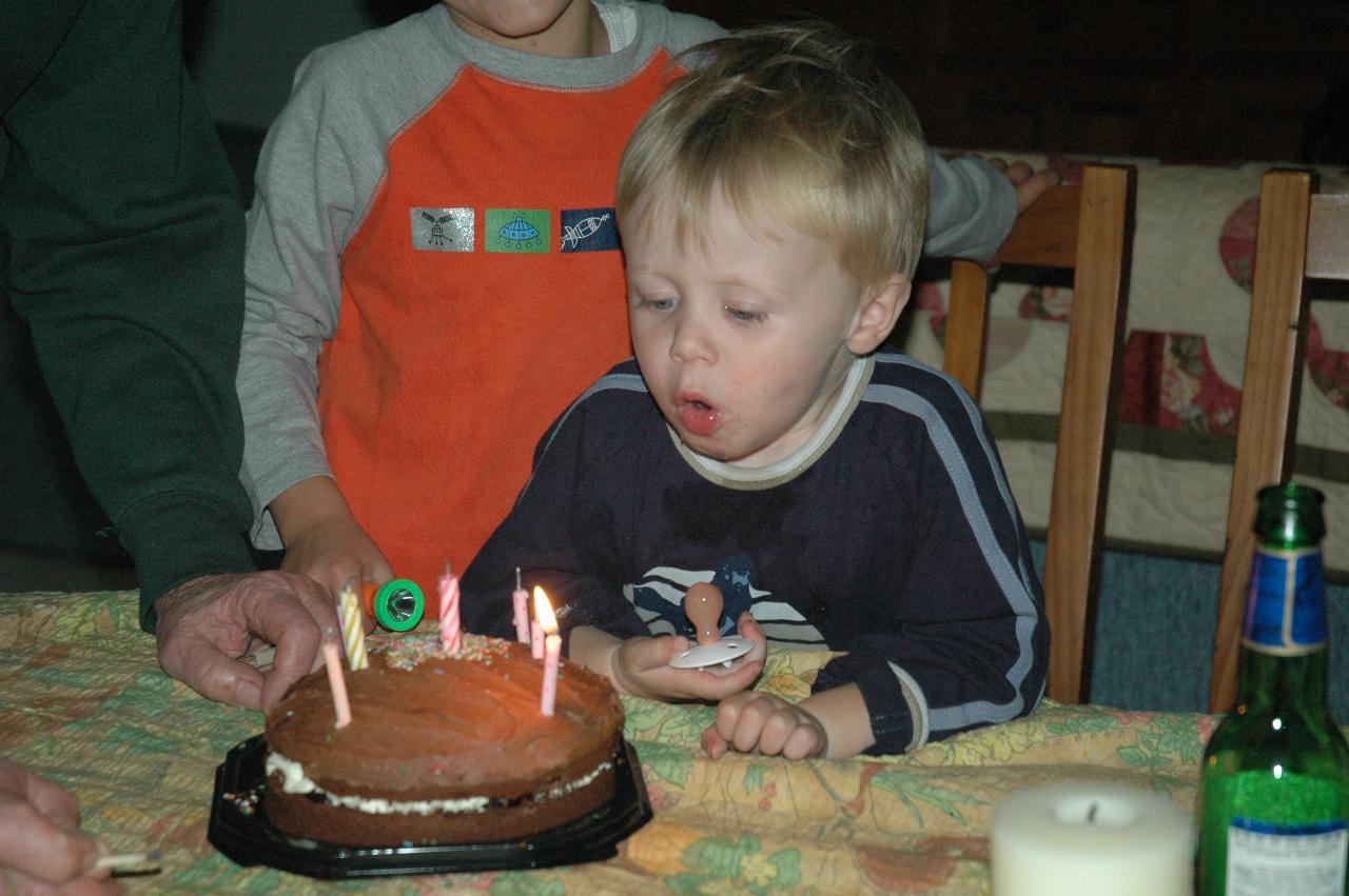 Flynn having another blow at the candles on Yvonne's birthday cake