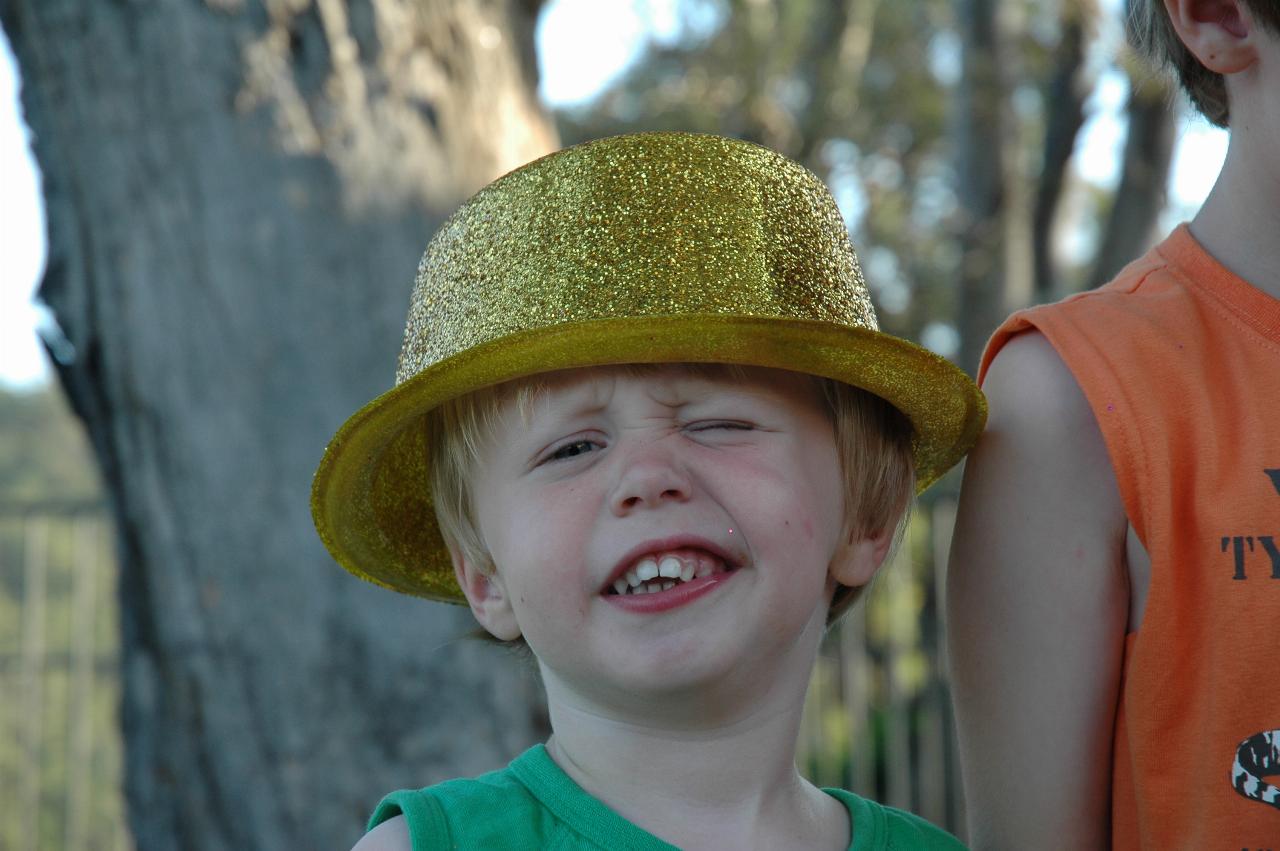 Flynn's third birthday: Winking Flynn with birthday hat