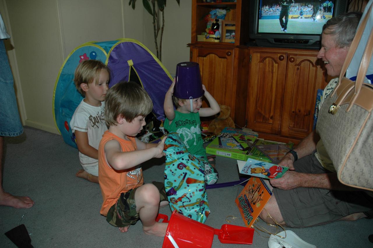 Flynn's third birthday: Riley, Jake and Flynn with bucket on head and Peter