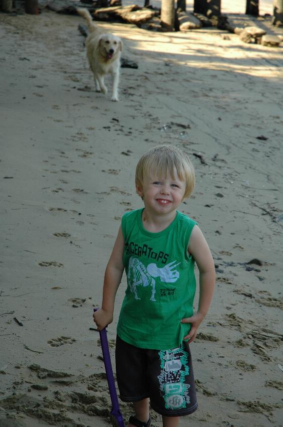 Flynn's third birthday: Flynn on beach with Keira, the neighbourhood dog