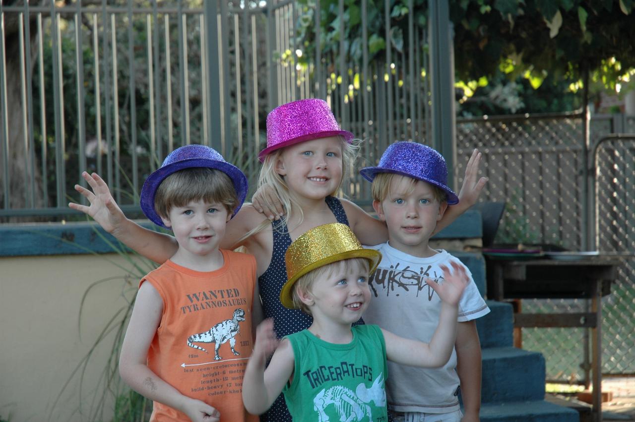 Flynn's third birthday: Jake, Ellie, FLynn and Riley with birthday hats