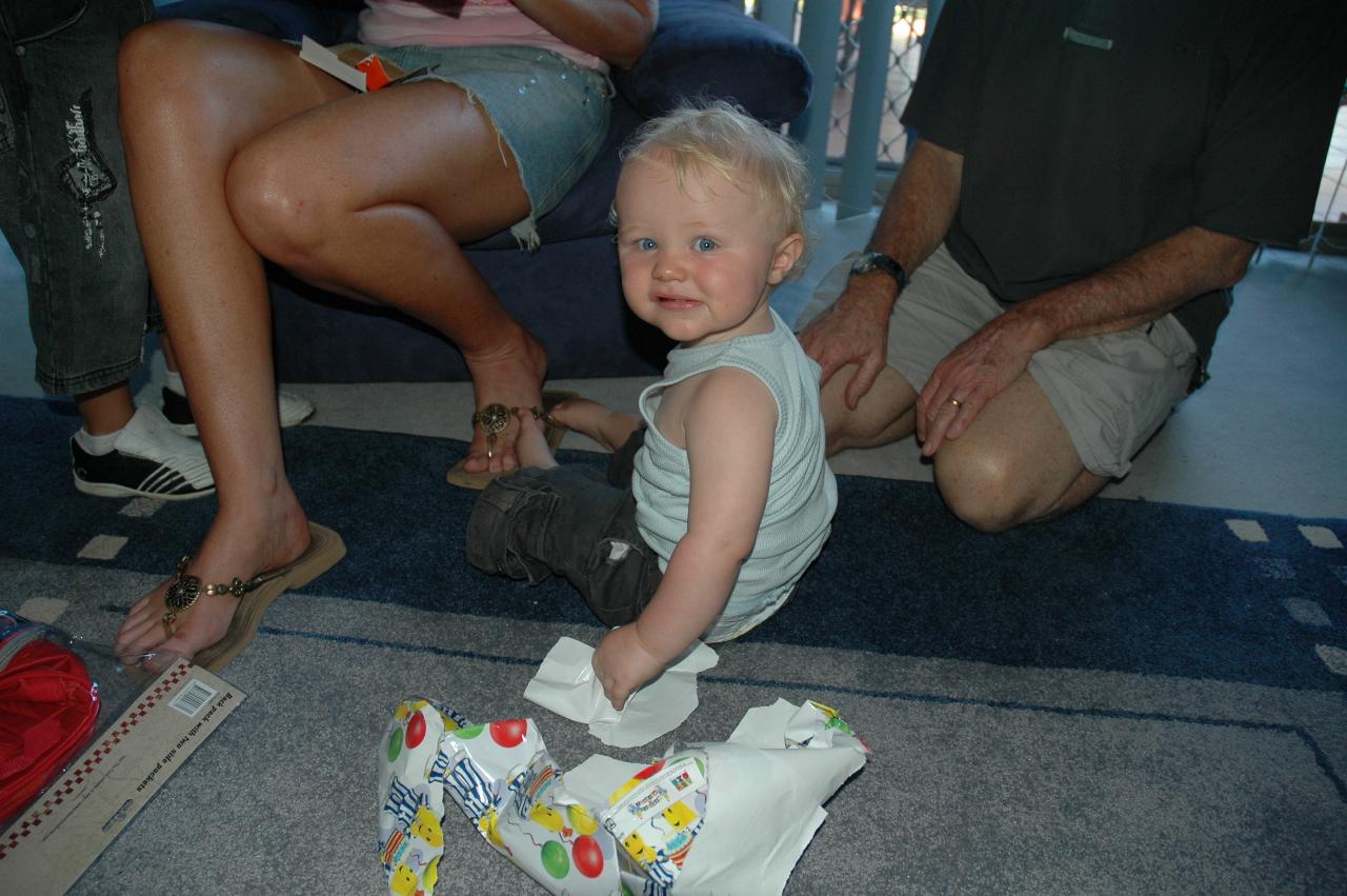 Cooper's First Birthday: Cooper with wrapping paper from one of his presents