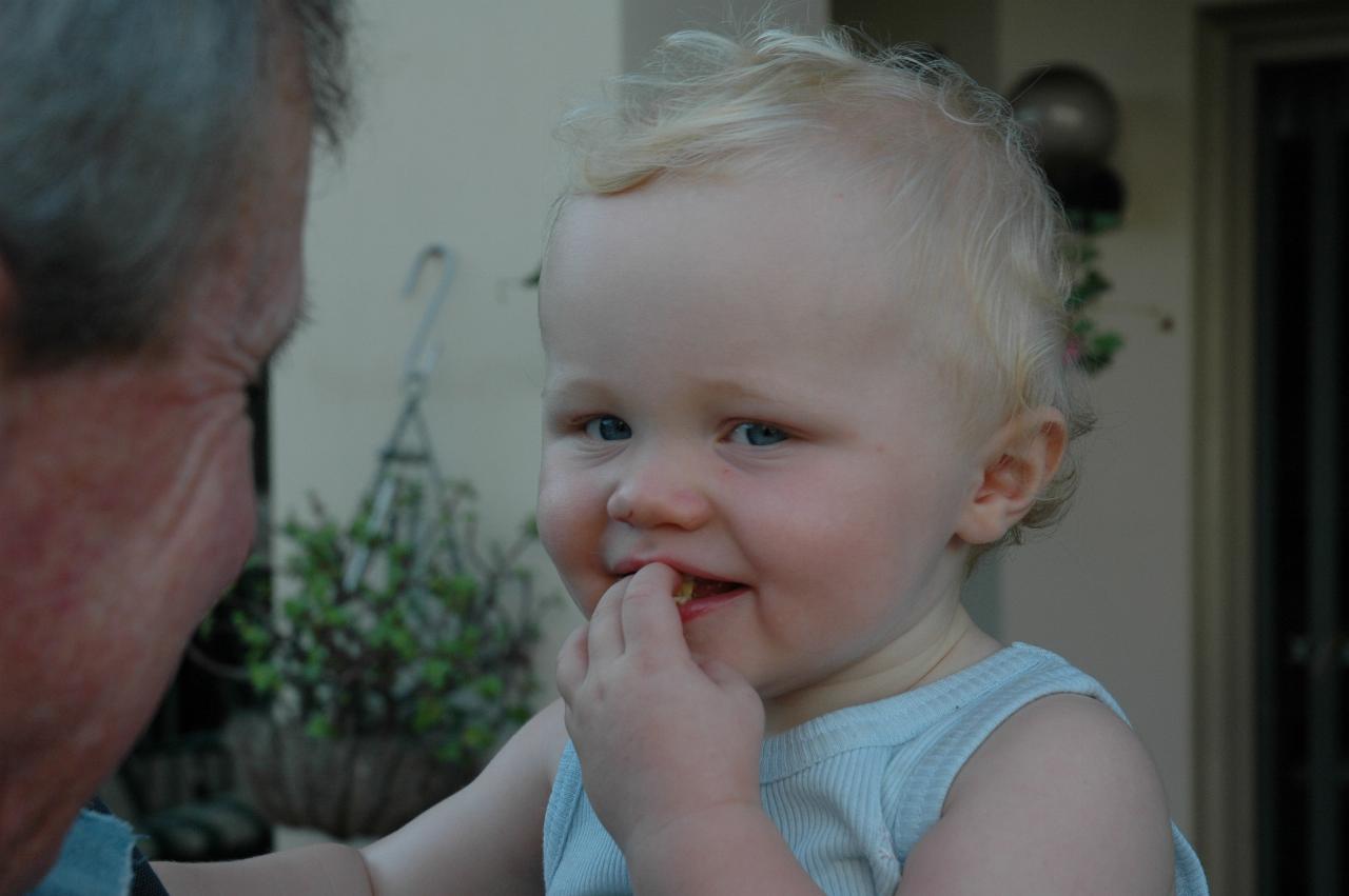 Cooper's First Birthday: Peter with Cooper and food in his mouth