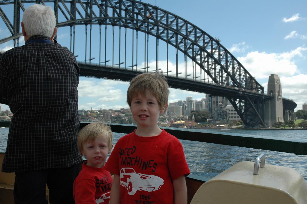 Luna Park Day: Flynn and Jake on the ferry to Milsons Point, with Luna Park visible under the bridge