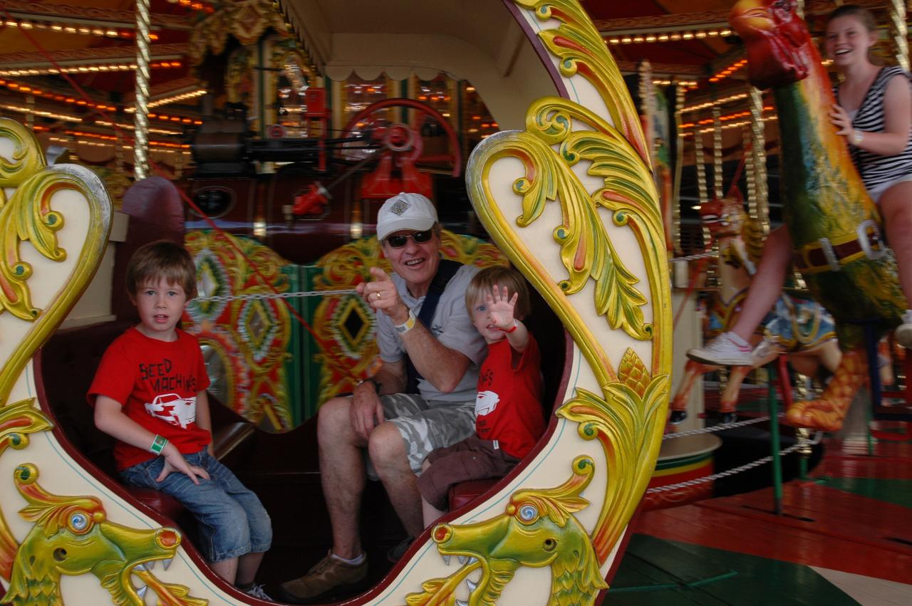 Luna Park Day: Jake, Peter and Flynn safely seated on carousel in motion