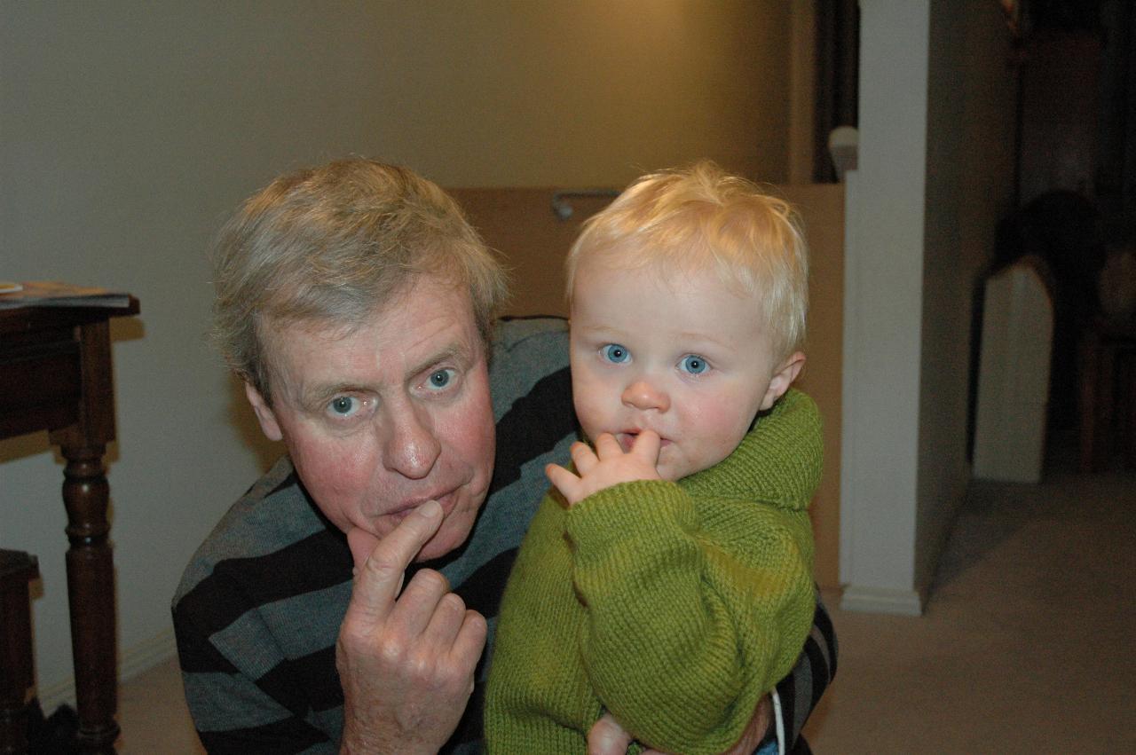 Baby and grandfather with finger to lips