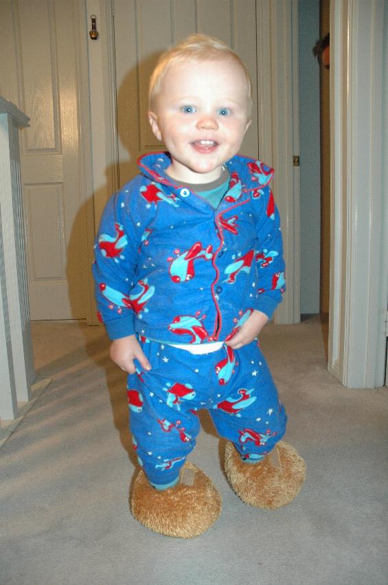 Baby in blue pyjamas walking towards camera