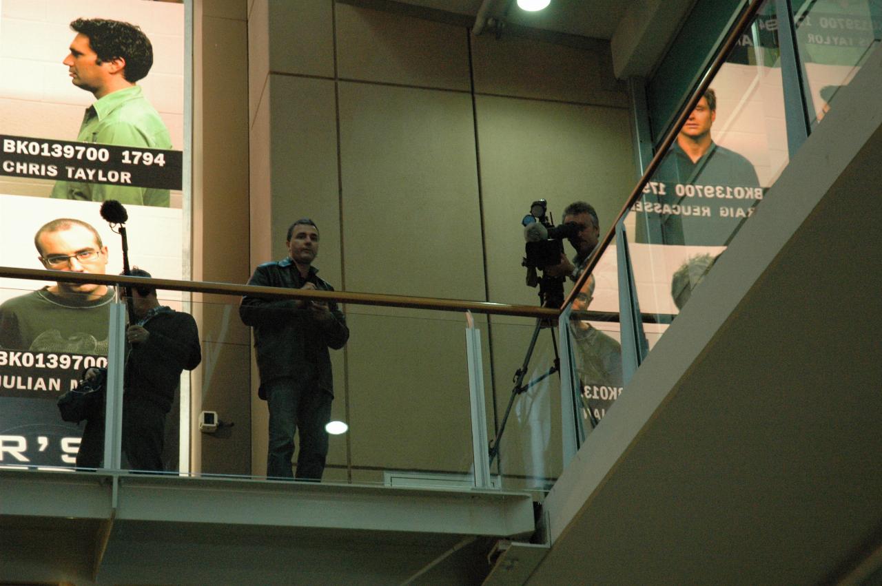 ABC cameraman recording crowd from second level balcony