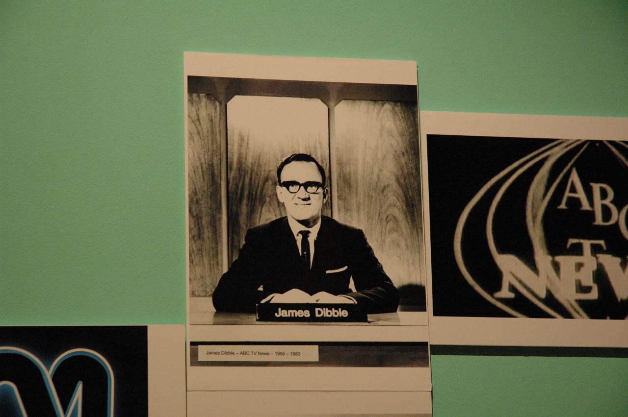 Photo of James Dibble seated at news desk