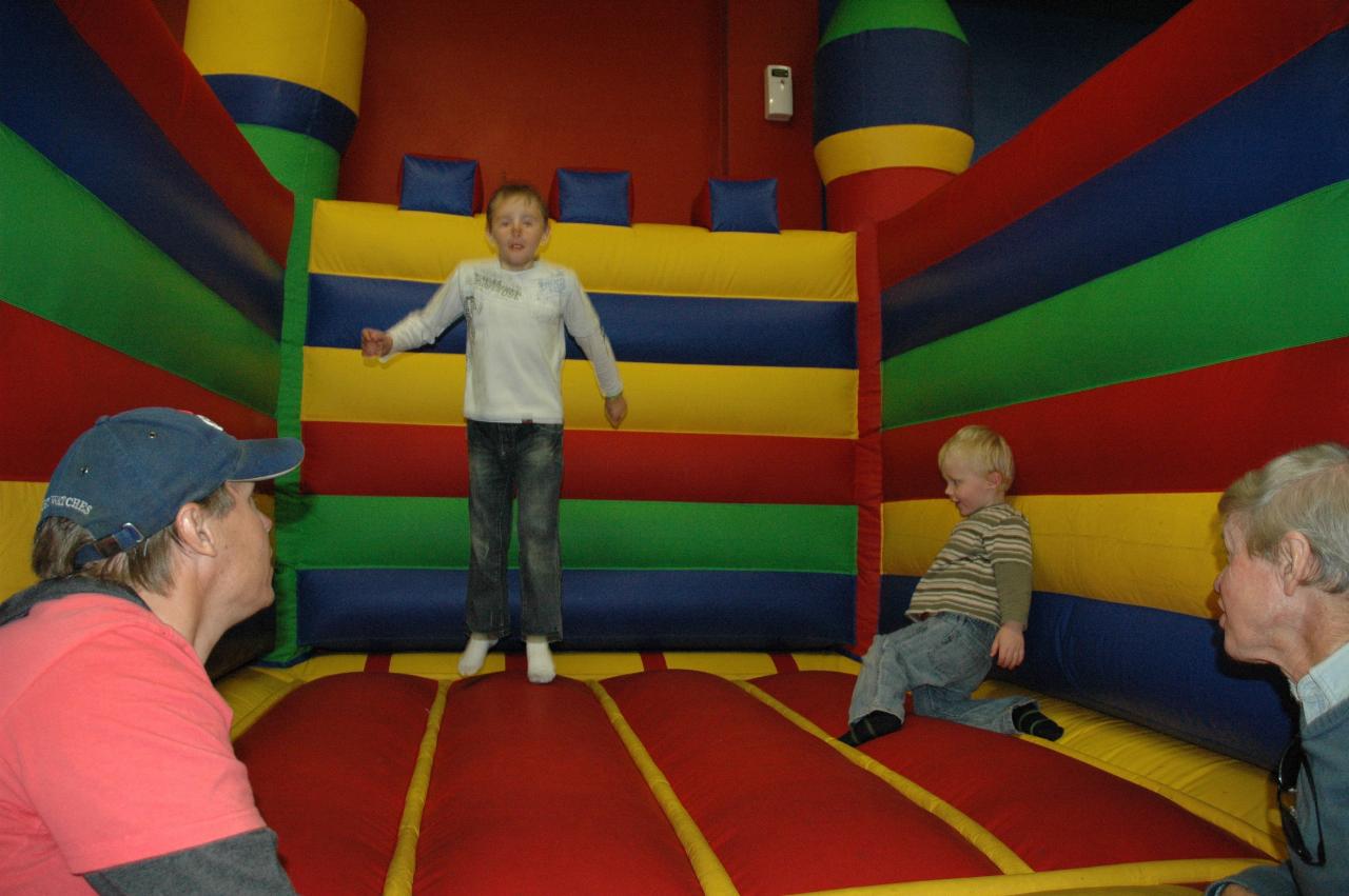 Jake's 7th birthday party at Club Kids, Earlwood: Tynan teaching Cooper to jump; Glenn and Peter look on