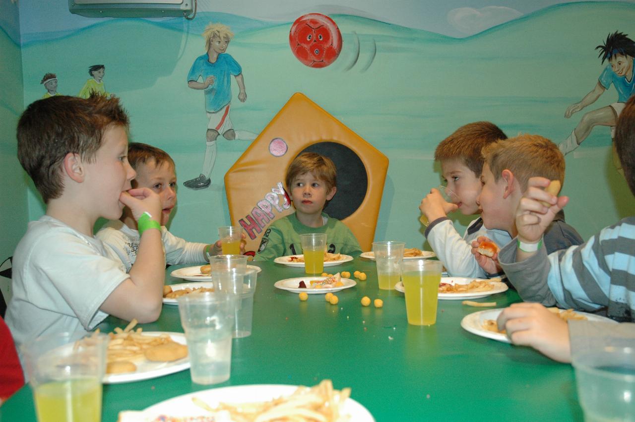 Jake's 7th birthday party at Club Kids, Earlwood: Eating time - Tynan and Jake at far end of table