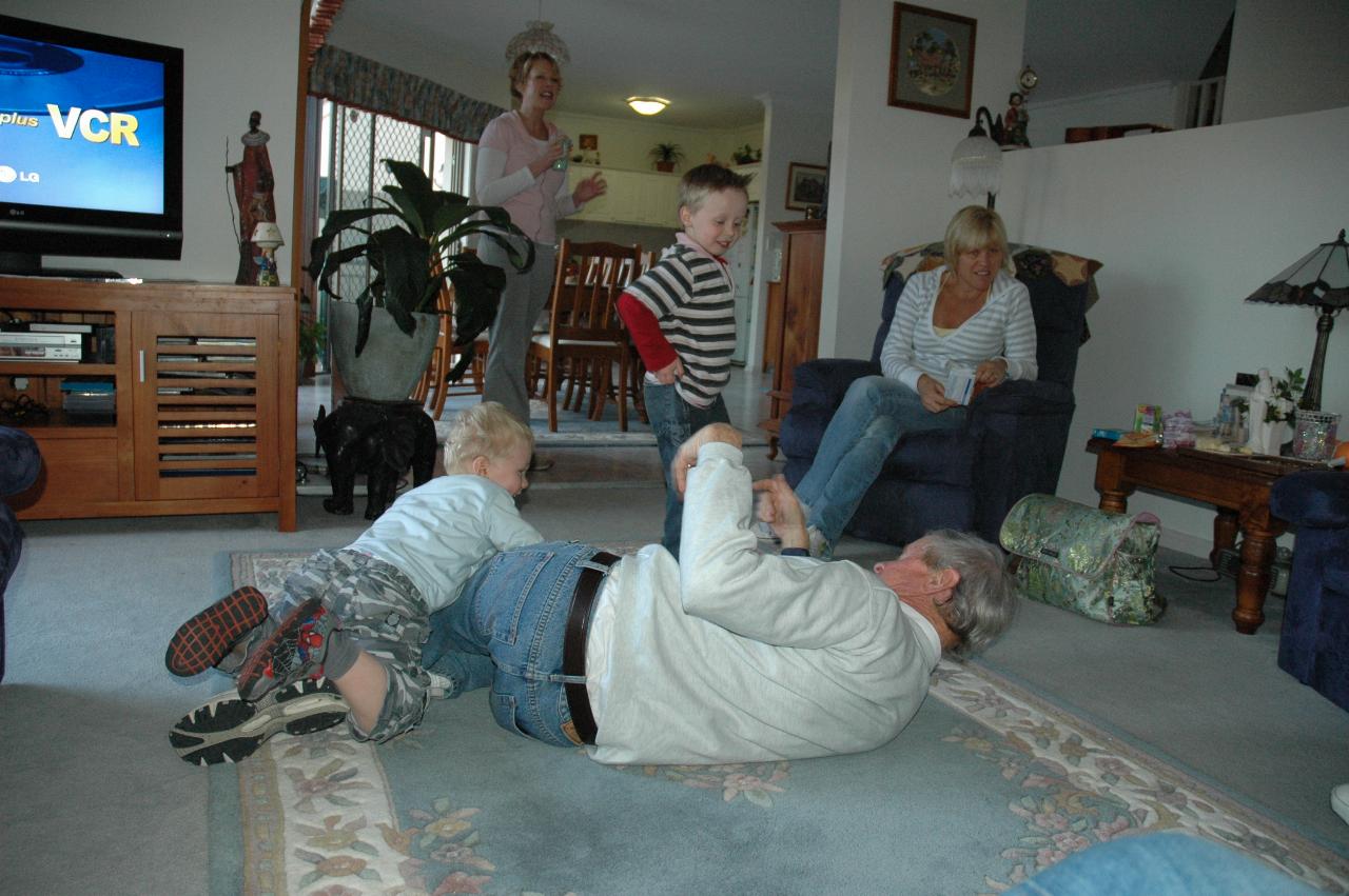 Peter with Flynn and Cooper on floor at Illawong; Michelle and Kelly in background