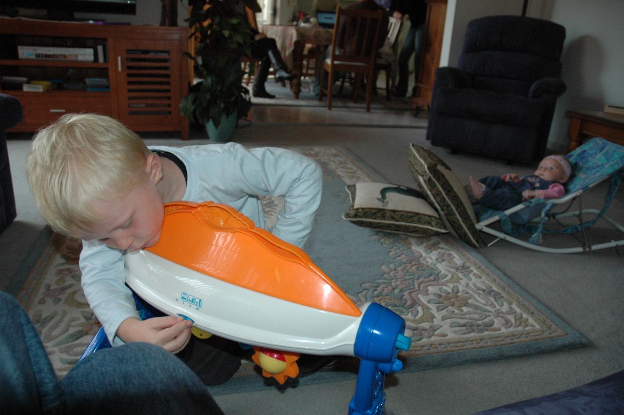 Family Dinner at Illawong: Cooper with the musical instrument and Lily in the background