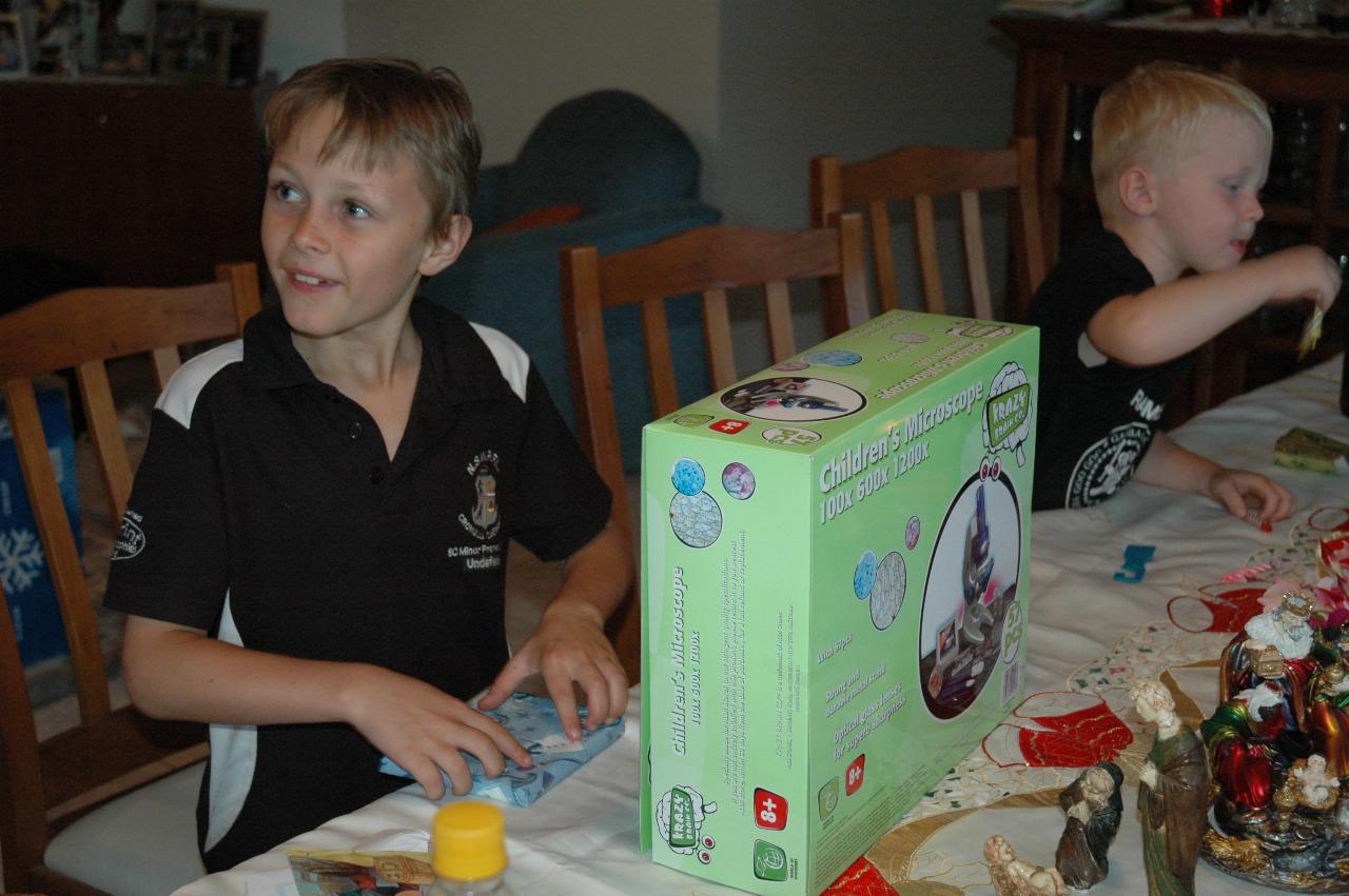 Christmas dinner at Illawong: Tynan with his birthday gifts - a microscope and Nintendo maths game