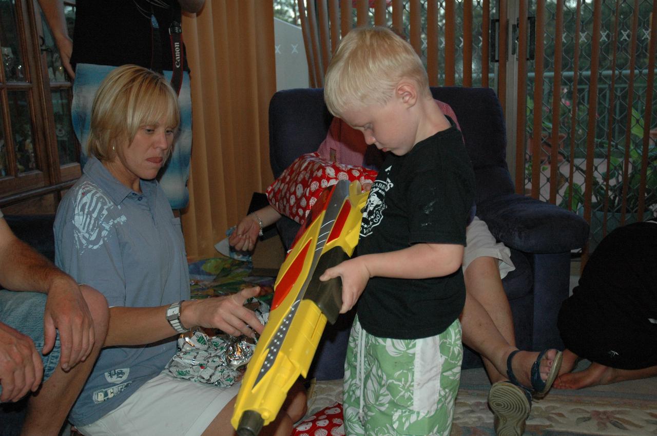 Christmas dinner at Illawong: Kelly explaining action of water pistol to Cooper