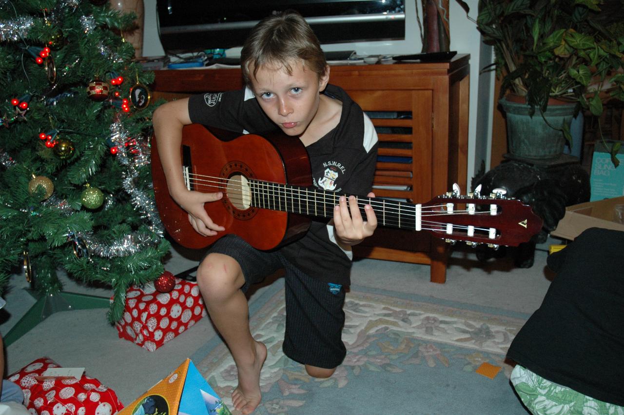 Christmas dinner at Illawong: Tynan practising his musician look with his Christmas present guitar