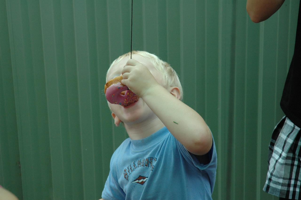 Cooper's 3rd birthday: Birthday boy cheating a bit to eat his donut