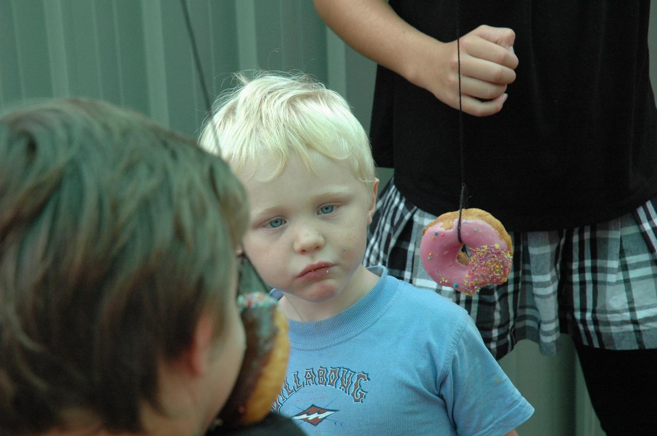 Cooper's 3rd birthday: Birthday boy cheating a bit to eat his donut