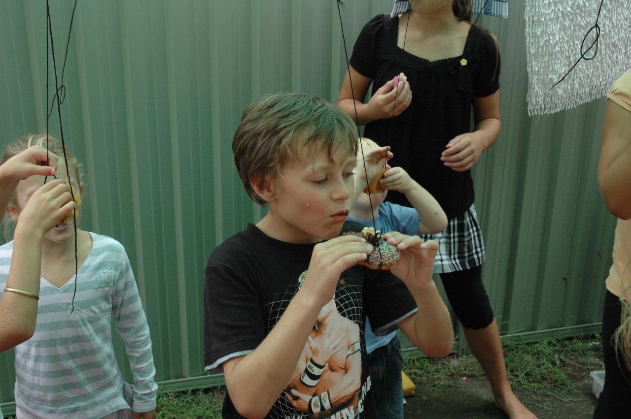 Cooper's 3rd birthday: Birthday boy cheating a bit to eat his donut