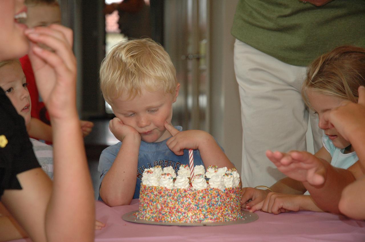 Cooper's 3rd birthday: The cake with candles starting to appear with Yvonne's help