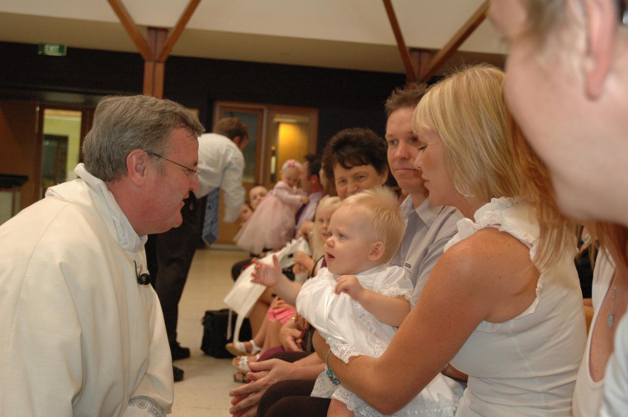 Lily's Baptism: Father Glen about to sign Lily