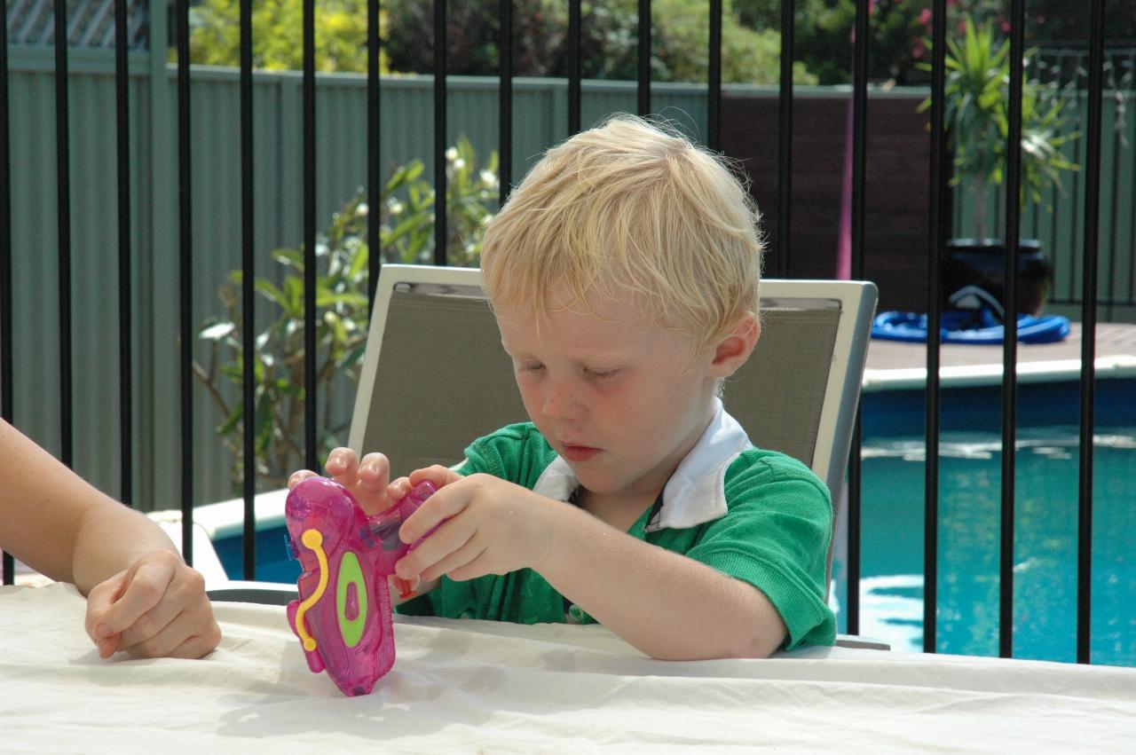 Lily's Baptism: Cooper with a water pistol