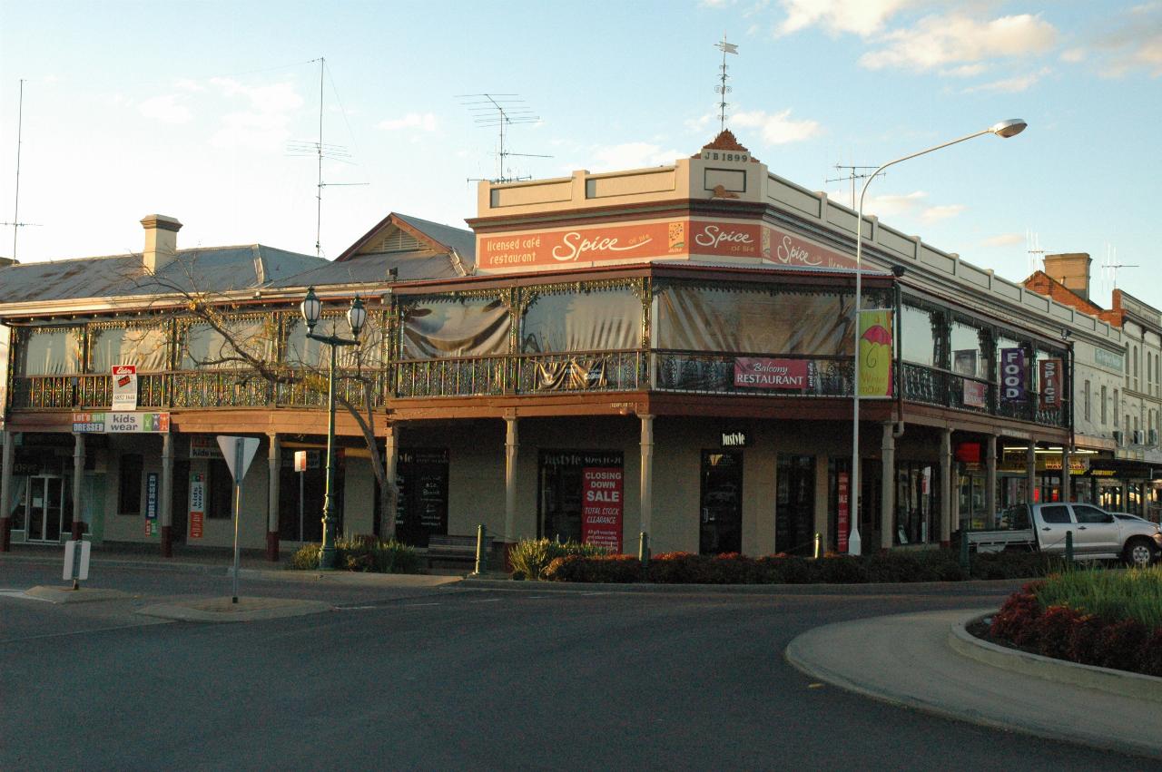 Two storey building with wooden verandah on top