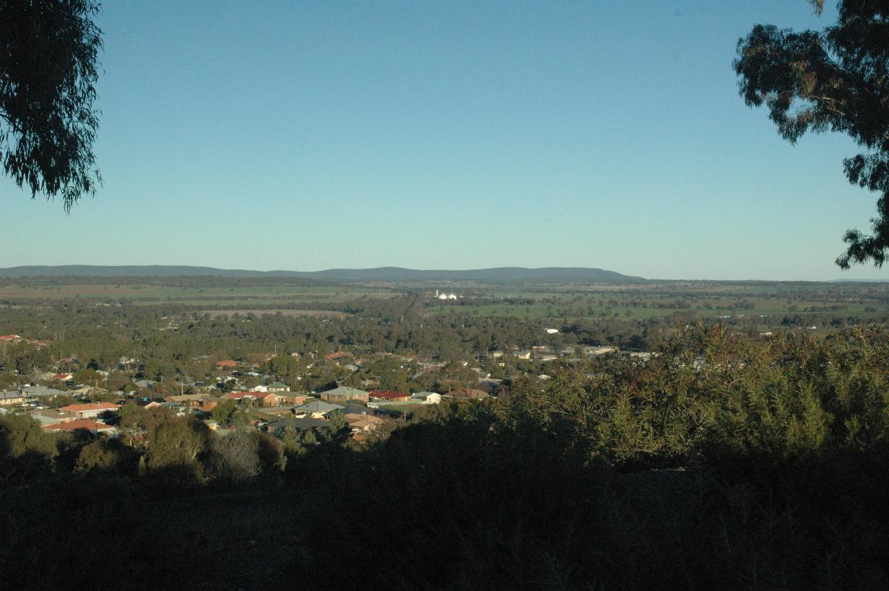 Nearby houses below to fields, bush and distant hills