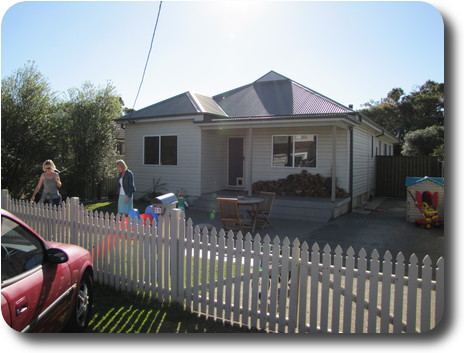 Wooden house with metal roof and pair in the front