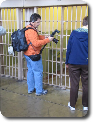 Photographer standing in front of a cell