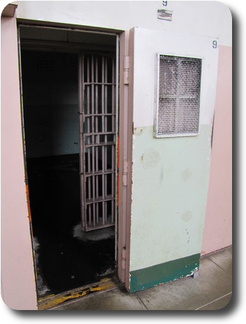 Entry to solitary cell; solid door with small window