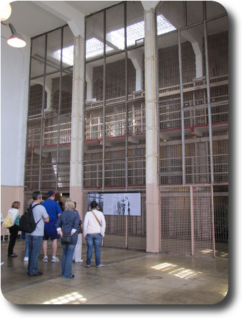 Space 3 floors high, looking through bars to 3 floors of regular cells