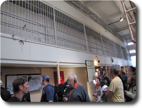 Gallery along wall enclosed behind bars