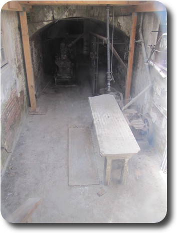 Room with wooden table at entrance to tunnel