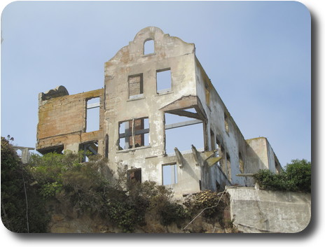 Cement building perched on the edge of a cliff