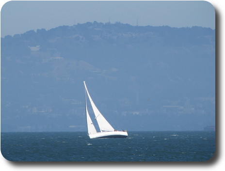 Sailing boat in front of hills