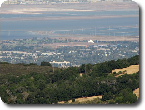 Nearby area looking over flat land adjacent to bay with buildings across the water