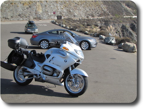 Silver motorcycle in parking lot of lookout